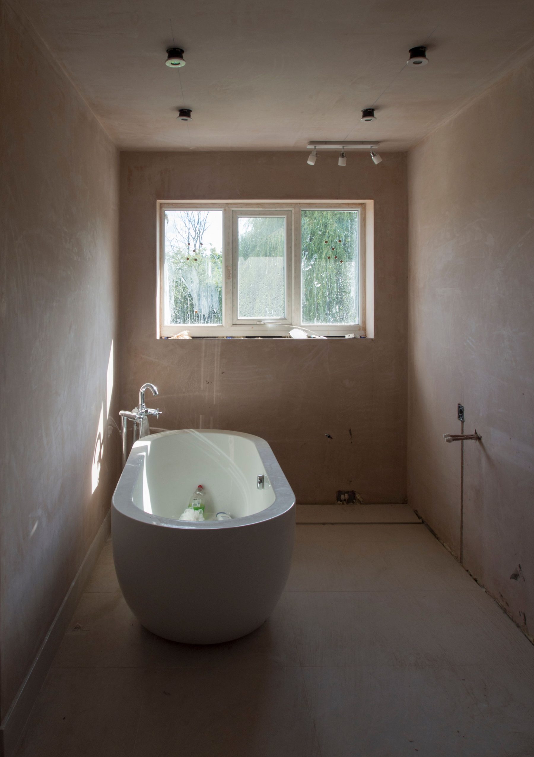 Bathroom renovation in progress with freestanding bath