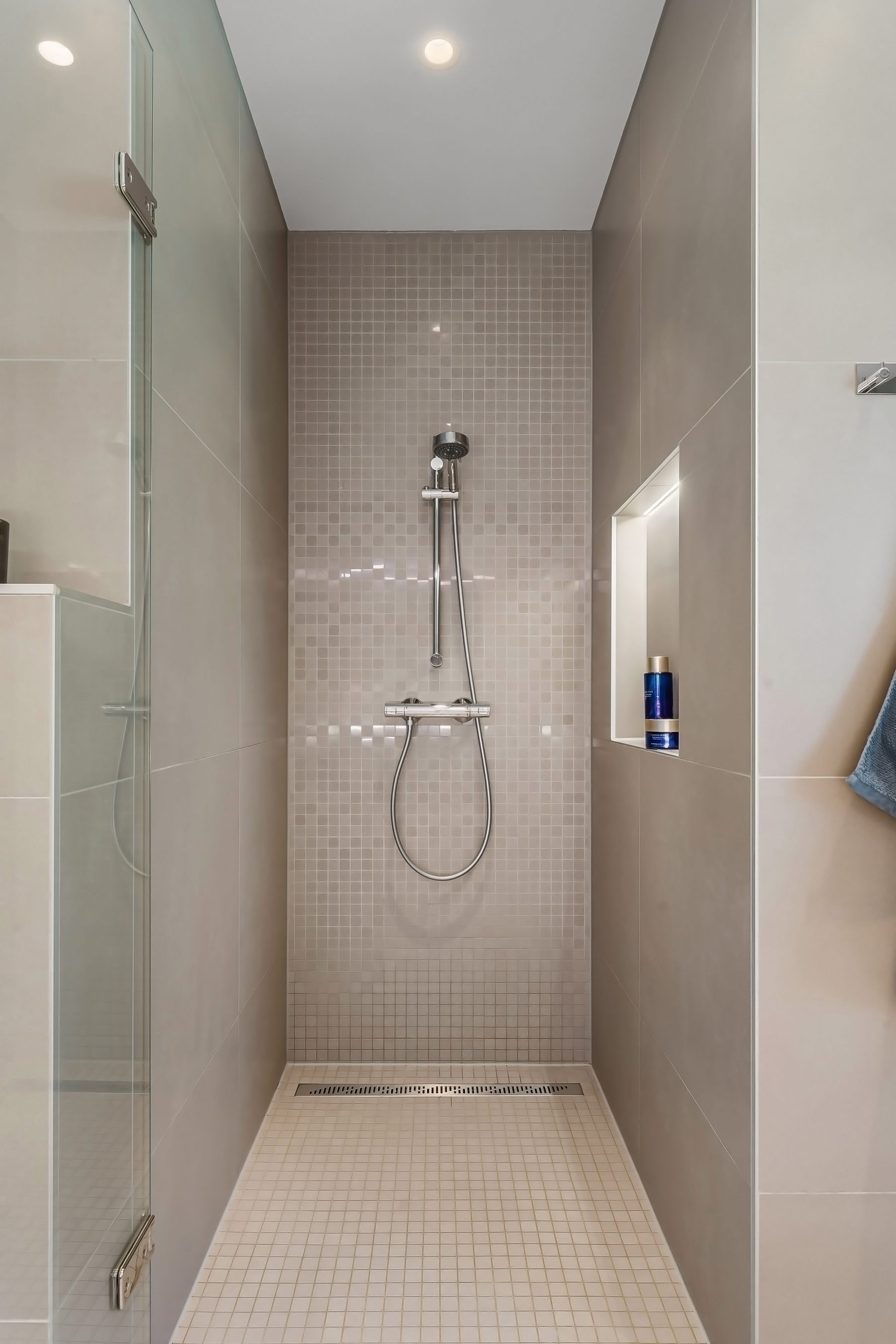 Modern tiled shower with glass screen